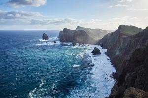 an aerial view of the ocean with a rocky coastline at Reid's Palace, A Belmond Hotel, Madeira in Funchal