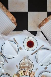 a table topped with plates and a cup of tea at Reid's Palace, A Belmond Hotel, Madeira in Funchal