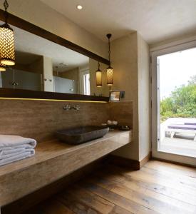 a bathroom with a sink and a large mirror at Hotel Unique-Boutique Class - Adults Only in Fethiye