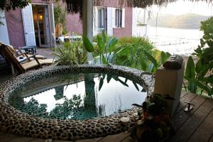a pool of water in a yard with a house at Hotel Unique-Boutique Class - Adults Only in Fethiye
