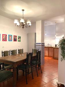 a dining room with a wooden table and chairs at Casa del Conde in Málaga
