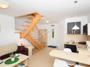 a living room and kitchen with a staircase in a house at Pod Muzami in Rewal