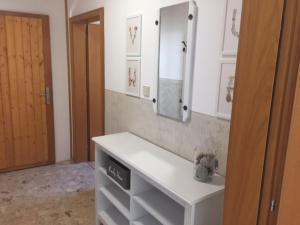 a bathroom with a white sink and a mirror at Haus ALPENBLICK in Malta +7 photos