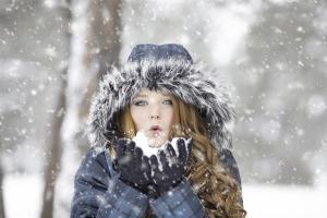 een jong meisje eten in de sneeuw bij Hunter's Lodge in Neve Ativ