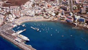 an aerial view of a harbor with boats in the water at First line sea, luxury penthouse, sea and sunset view Vivenda Vacational Guayero 618 in Los Cristianos