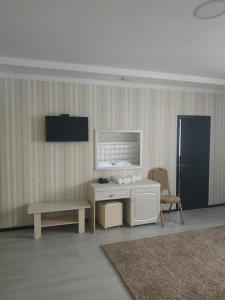 a living room with a desk and a chair at Турист in Taraz