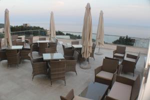 a restaurant with tables and chairs and umbrellas at Casa Hena in Ulcinj