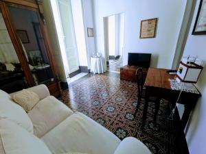 ein Wohnzimmer mit einem Sofa und einem Tisch in der Unterkunft Fera O' Luni in Catania