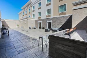 an outdoor patio with a fireplace in front of a building at Holiday Inn Longview - North, an IHG Hotel in Longview