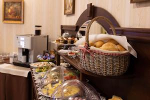 a buffet with bread and other food on a table at Hotel Panorama in Ostrowiec Świętokrzyski