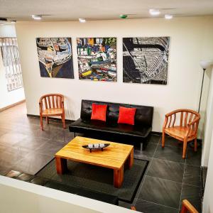 a living room with a couch and two chairs at Apart Hotel Viva Providencia in Santiago +36 photos