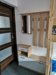a bedroom with a wooden bunk bed with a mirror at For rest Hostel in Lublin