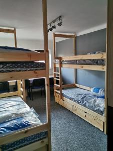 a room with three bunk beds and a table at For rest Hostel in Lublin