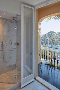 a bathroom with a shower with a glass door at Splendido, A Belmond Hotel, Portofino in Portofino