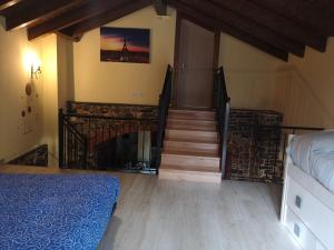 a bedroom with a staircase with a bed and a fireplace at Casa Rural Rio Cabrera in Las Médulas