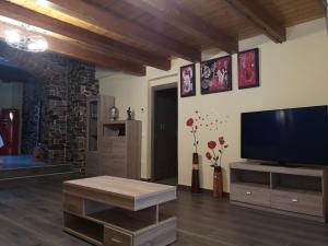 a living room with a flat screen tv on the wall at Casa Rural Rio Cabrera in Las Médulas +12 photos