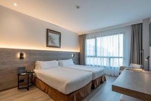 Ein Bett oder Betten in einem Zimmer der Unterkunft Attica 21 Barcelona Mar