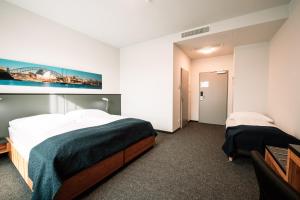 Ένα ή περισσότερα κρεβάτια σε δωμάτιο στο Motel Grieskirchen superior