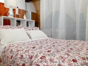 a bedroom with a large bed with a floral bedspread at Il mito in Castellaneta