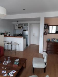 a living room and kitchen with a table and chairs at Lo de Mario al rio in Buenos Aires