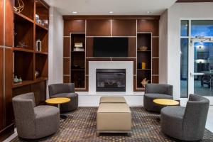 a living room with chairs and a fireplace at Holiday Inn - Gulfport-Airport, an IHG Hotel in Gulfport