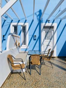a balcony with chairs and a table on a ship at Pontamos Villas in Halki