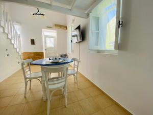 a kitchen and dining room with a table and chairs at Pontamos Villas in Halki +8 photos