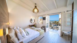 a bedroom with a bed and a view of the ocean at PLAZAsuite1600 in Rethymno