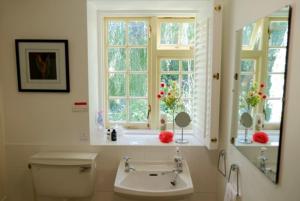a bathroom with a toilet and a sink and windows at Bagnell Farm Cottage in Chiselborough +52 photos