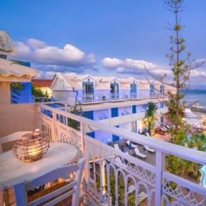 einen Balkon mit Blick auf das Meer und ein Gebäude in der Unterkunft Pierros Hotel in Laganas