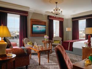 a hotel room with a bed and a living room at The Hardiman (formerly Hotel Meyrick) in Galway