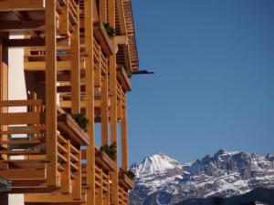 a building with the mountains in the background at Dolomiti Lodge Villa Gaia in Venas