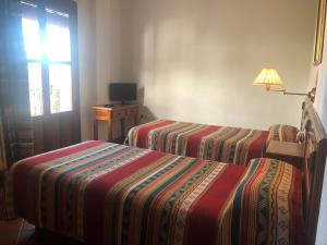 Postel nebo postele na pokoji v ubytování Hostal Rural Poqueira