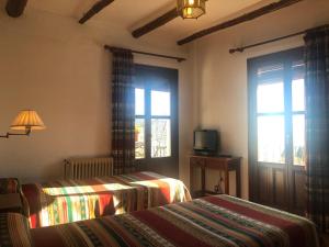 Postel nebo postele na pokoji v ubytování Hostal Rural Poqueira