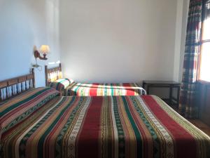 Postel nebo postele na pokoji v ubytování Hostal Rural Poqueira