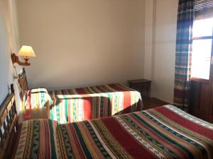 Postel nebo postele na pokoji v ubytování Hostal Rural Poqueira