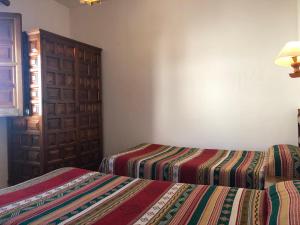 Postel nebo postele na pokoji v ubytování Hostal Rural Poqueira