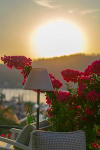 a lamp sitting on top of a table with flowers at Hotel Unique-Boutique Class - Adults Only in Fethiye