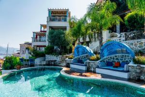 a pool at a hotel with chairs and a building at Hotel Unique-Boutique Class - Adults Only in Fethiye