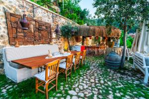 a patio with a wooden table and chairs at Hotel Unique-Boutique Class - Adults Only in Fethiye