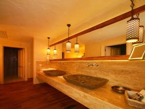 a bathroom with two sinks and a large mirror at Hotel Unique-Boutique Class - Adults Only in Fethiye