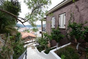 a building with a walkway next to a house at Hotel Unique-Boutique Class - Adults Only in Fethiye