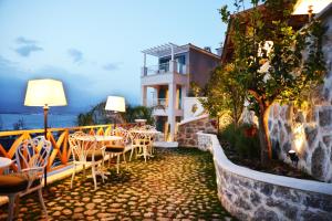 a patio with tables and chairs in front of a building at Hotel Unique-Boutique Class - Adults Only in Fethiye