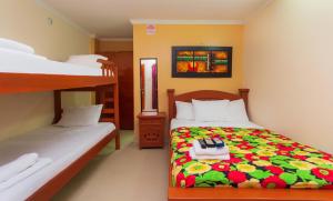 a bedroom with two beds and a bunk bed at Hotel Boquilla Suites By GEH Suites in Cartagena de Indias