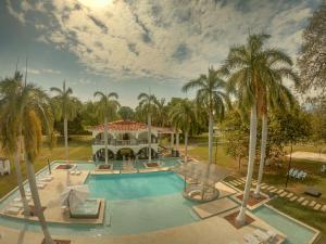 an aerial view of a resort swimming pool with palm trees at Hotel Arena Santa Fe de Antioquia in Santa Fe de Antioquia