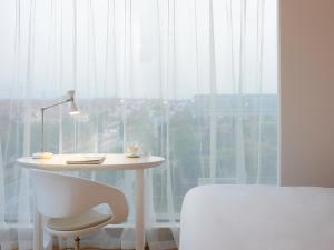 Postel nebo postele na pokoji v ubytování FlyZoo Hotel - Alibaba Future Hotel