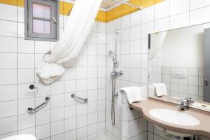 a bathroom with a sink and a shower at SOWELL RESIDENCES Chênes Verts in Saint-Raphaël