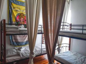 a dorm room with bunk beds and a window at Urban Yoga House Hostel & Retreat in Ioannina