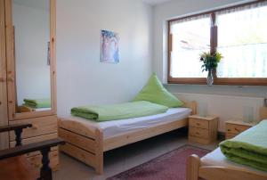 a bedroom with a bed and a window and a mirror at Weingut & Ferienwohnungen Kirch in Nordheim