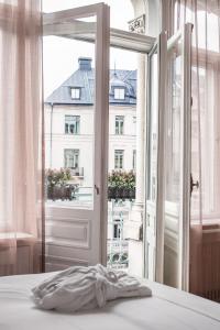 a bedroom with a window with a view of a building at The Sparrow Hotel in Stockholm
